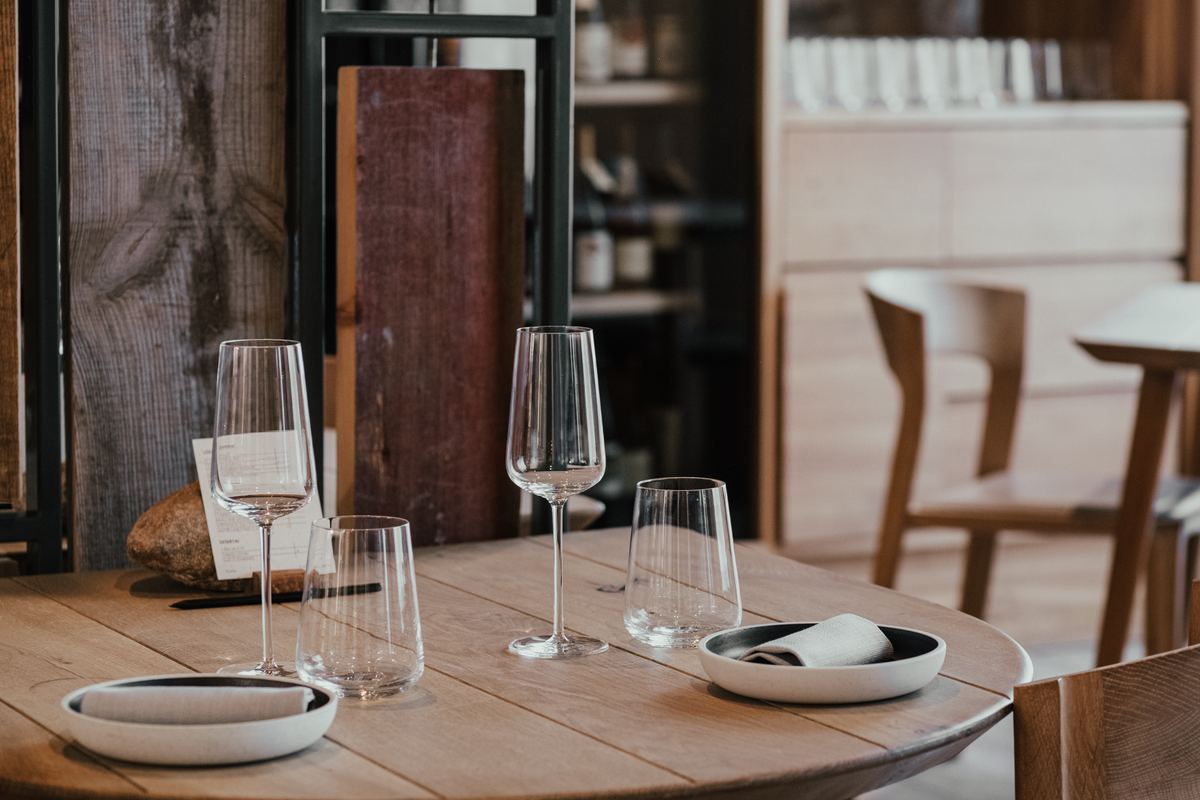 A glass of wine on a set table